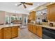 Bright kitchen features wooden cabinets, stone countertops, backsplash, and connects to a dining area and living room at 17 Sassafras Ne Trl, Cartersville, GA 30121