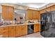 Kitchen featuring wooden cabinets, stainless steel sink and appliances with a pass-through to an adjacent room at 17 Sassafras Ne Trl, Cartersville, GA 30121