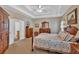 Spacious main bedroom suite with tray ceilings, carpet, and an ensuite bathroom at 17 Sassafras Ne Trl, Cartersville, GA 30121