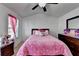 Bright bedroom featuring a ceiling fan and a cozy pink comforter at 2639 Cooper Brook Dr, Snellville, GA 30078