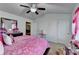 Bright bedroom featuring a ceiling fan and a cozy pink comforter at 2639 Cooper Brook Dr, Snellville, GA 30078
