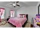 Bright bedroom featuring a ceiling fan and a cozy pink comforter at 2639 Cooper Brook Dr, Snellville, GA 30078