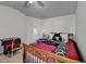 Bedroom features patterned bedding, complementary decor, and a ceiling fan at 2639 Cooper Brook Dr, Snellville, GA 30078