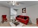 Bright bonus room featuring a comfortable red sofa and neutral carpet at 2639 Cooper Brook Dr, Snellville, GA 30078