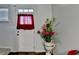 Entryway features white door with sheer red curtains and ornamental decor at 2639 Cooper Brook Dr, Snellville, GA 30078