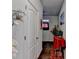 Hallway with a decorative table with red furnishings and hardwood floors at 2639 Cooper Brook Dr, Snellville, GA 30078
