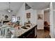 Open kitchen with granite countertop island, hardwood floors, and a view to the living room at 2639 Cooper Brook Dr, Snellville, GA 30078