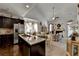 Open kitchen with dark cabinets, granite countertops, and stainless steel appliances at 2639 Cooper Brook Dr, Snellville, GA 30078