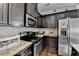 Updated kitchen with granite counters, dark wood cabinets, and stainless steel appliances at 2639 Cooper Brook Dr, Snellville, GA 30078