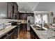 Modern kitchen with granite countertops, dark cabinetry, and stainless steel appliances at 2639 Cooper Brook Dr, Snellville, GA 30078