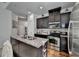 Well-lit kitchen with stainless steel appliances, granite countertops, and dark cabinets at 2639 Cooper Brook Dr, Snellville, GA 30078