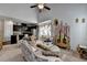 Bright living room and kitchen area with ornate decor, ceiling fan, and natural light from a bay window at 2639 Cooper Brook Dr, Snellville, GA 30078