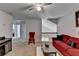Cozy living area featuring plush red sofa, chair, and ceiling fan, creating a comfortable space at 2639 Cooper Brook Dr, Snellville, GA 30078