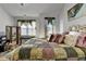 Main bedroom with chandelier, bed, dresser, and windows allowing plenty of natural light to filter in at 2639 Cooper Brook Dr, Snellville, GA 30078