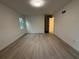 Empty bedroom with new floors and neutral walls with a window, and a closet at 3663 Heatherwood Ne Dr, Marietta, GA 30066