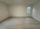 Spacious bedroom featuring new flooring, neutral walls, and a window with a view at 3663 Heatherwood Ne Dr, Marietta, GA 30066