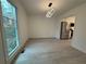 Bright dining room featuring a modern chandelier and large window showcasing the outdoor scenery at 3663 Heatherwood Ne Dr, Marietta, GA 30066