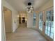 Dining area with modern lighting, doors to the deck, and an open view into the kitchen at 3663 Heatherwood Ne Dr, Marietta, GA 30066
