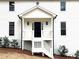 A black front door framed by white trim and a covered porch adds classic charm at 3663 Heatherwood Ne Dr, Marietta, GA 30066
