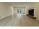 Living room with hardwood floors, brick fireplace, and large windows at 3663 Heatherwood Ne Dr, Marietta, GA 30066