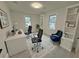 Bright office with two workstations, stylish blue accent chair, and built-in shelving at 3663 Heatherwood Ne Dr, Marietta, GA 30066