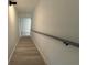 Well-lit stairway with modern black sconce and handrail, offering a clean aesthetic at 3663 Heatherwood Ne Dr, Marietta, GA 30066