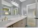 Bathroom with double sinks, marble countertops, large mirrors, and access to bedroom at 462 Connally Se St, Atlanta, GA 30312