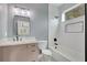 Modern bathroom features white subway tile, black fixtures, marble countertop and a sleek, frameless mirror at 462 Connally Se St, Atlanta, GA 30312