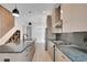 Modern kitchen featuring a large island with pendant lighting, stainless appliances, and stylish backsplash at 462 Connally Se St, Atlanta, GA 30312