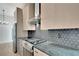 Close-up of modern kitchen featuring stainless steel appliances and custom backsplash at 462 Connally Se St, Atlanta, GA 30312