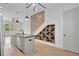 Modern kitchen island featuring a sink, dishwasher, and storage with a wine rack and hardwood floors at 462 Connally Se St, Atlanta, GA 30312