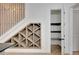 Staircase featuring a decorative wooden accent, alongside a wine rack, and access to a closet with wooden shelves at 462 Connally Se St, Atlanta, GA 30312