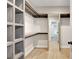 Walk-in closet featuring custom shelving, wooden floors, and ample storage space at 462 Connally Se St, Atlanta, GA 30312