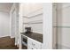 Convenient butler's pantry area featuring granite countertops, wine fridge, glass shelves, and coffee station at 5170 Chemin De Vie Ne, Sandy Springs, GA 30342