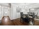 Elegant dining area with hardwood floors adjacent to the entry and featuring views of the kitchen at 5170 Chemin De Vie Ne, Sandy Springs, GA 30342