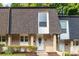 Charming townhome with brick facade, complemented by a well-manicured lawn and tasteful landscaping at 5170 Chemin De Vie Ne, Sandy Springs, GA 30342