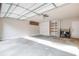 Spacious garage with ample storage including wall shelving and cabinets, with a bright, clean concrete floor at 5170 Chemin De Vie Ne, Sandy Springs, GA 30342
