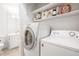Well-organized laundry room with washer, dryer and plenty of space for storage of supplies at 5170 Chemin De Vie Ne, Sandy Springs, GA 30342