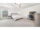Spacious main bedroom featuring large windows, ceiling fan and neutral tones at 5170 Chemin De Vie Ne, Sandy Springs, GA 30342