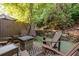 Cozy patio area featuring outdoor furniture, stylish rug, and lush natural surroundings and a stone retaining wall at 5170 Chemin De Vie Ne, Sandy Springs, GA 30342