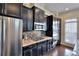 Modern kitchen with dark cabinets, stainless steel appliances, and granite countertops at 1306 Harris Way, Brookhaven, GA 30319