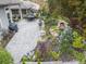 Aerial view of the lush backyard with stone waterfall feature, adjacent to an outdoor kitchen and dining area at 218 Floral Valley Dr, Woodstock, GA 30188