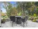 Backyard patio with outdoor table, fire pit, and expertly landscaped yard create a relaxing outdoor space at 218 Floral Valley Dr, Woodstock, GA 30188