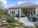 Professionally landscaped backyard features an outdoor kitchen, fire pit table, and lush greenery for outdoor enjoyment at 218 Floral Valley Dr, Woodstock, GA 30188