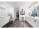 This bathroom features dual sinks, white cabinets, and a grey tiled floor, exuding a clean, modern style at 218 Floral Valley Dr, Woodstock, GA 30188