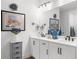 Elegant bathroom with double sinks, white cabinetry, and stylish lighting fixtures at 218 Floral Valley Dr, Woodstock, GA 30188