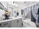 Cozy bathroom featuring a grey vanity, decorative accents, and a shower with a charming bird-themed curtain at 218 Floral Valley Dr, Woodstock, GA 30188