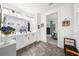 Bright bathroom with double vanity, modern fixtures, and elegant tile flooring at 218 Floral Valley Dr, Woodstock, GA 30188