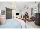 Bedroom with a large bed, chandelier, and view to the bathroom through a sliding barn door at 218 Floral Valley Dr, Woodstock, GA 30188