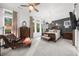 Spacious bedroom with large windows, hardwood floors, and a stylish chaise lounge at 218 Floral Valley Dr, Woodstock, GA 30188